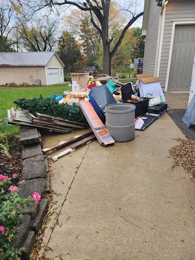 Dumpster being loaded with debris for Roofing Dumpster Rental in Crandall